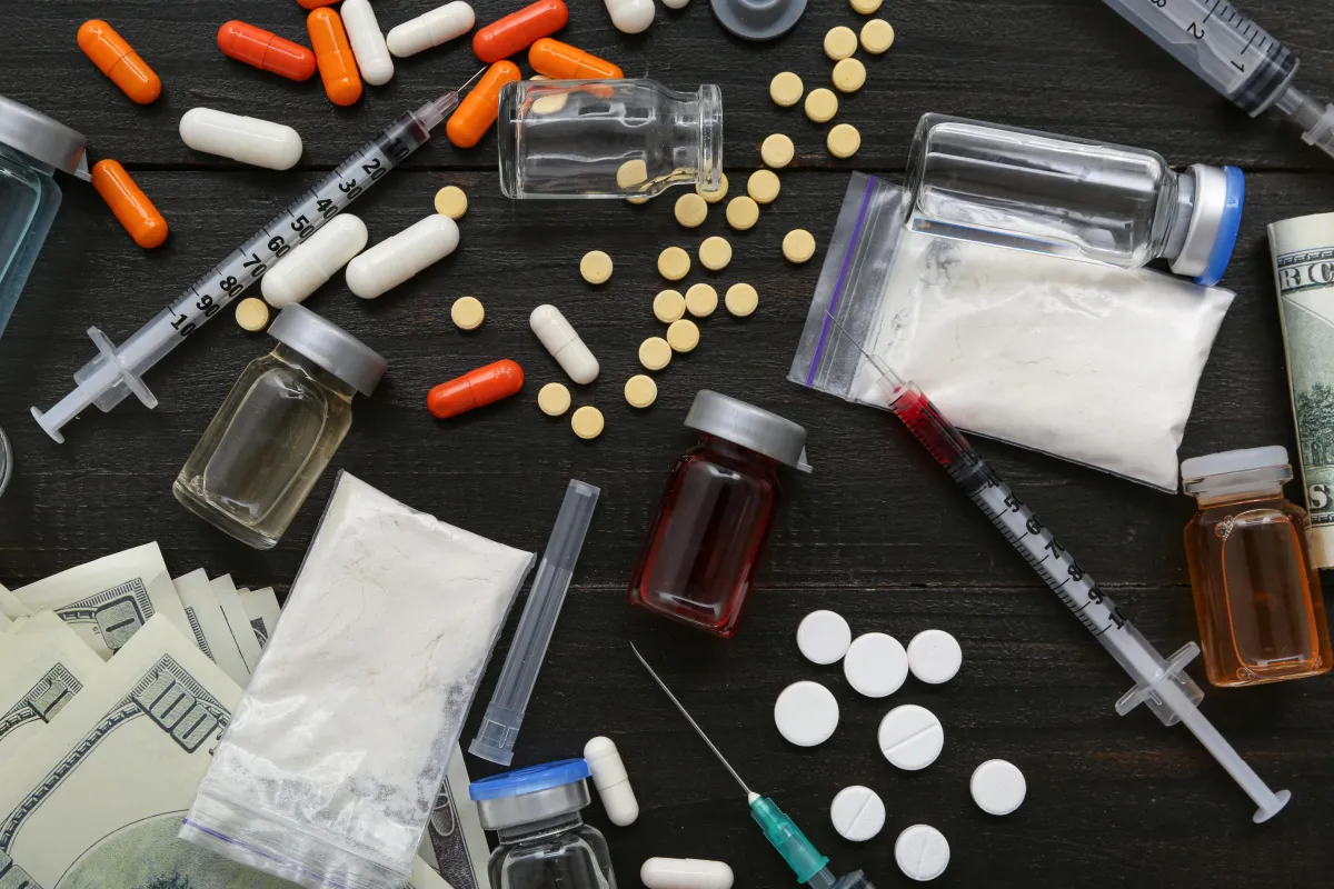 Pills, drugs and syringes on a table