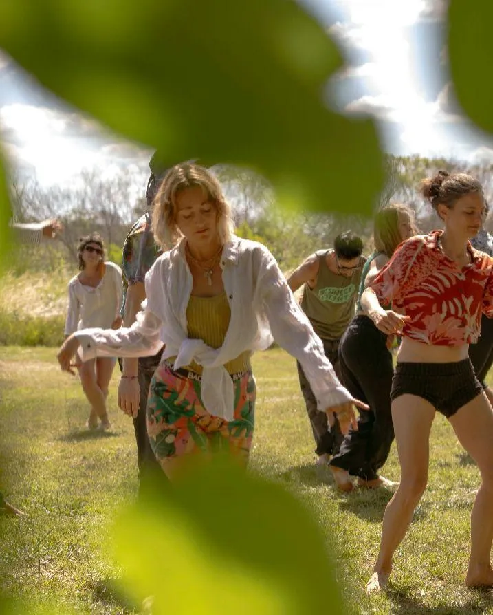 A calm pond surrounded by lush green trees.