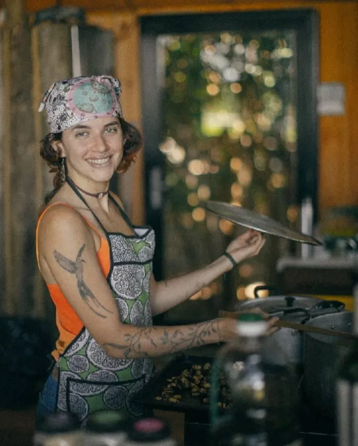 a group of people sitting on top of a lush green field