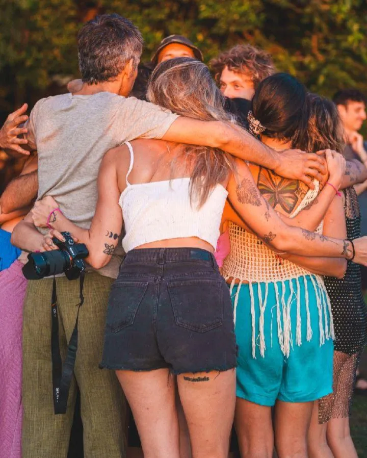 A calm pond surrounded by lush green trees.