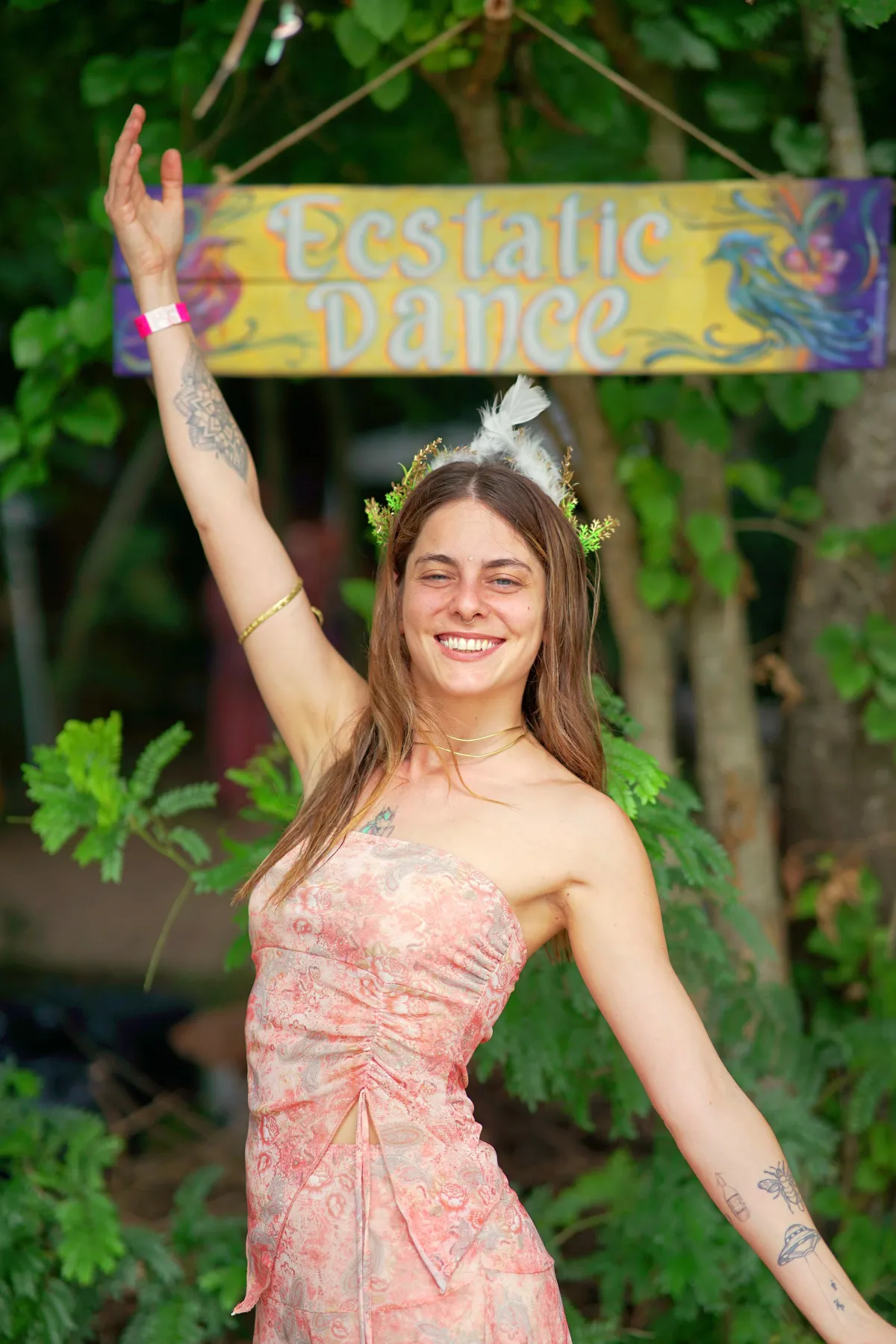 a group of people sitting on top of a lush green field