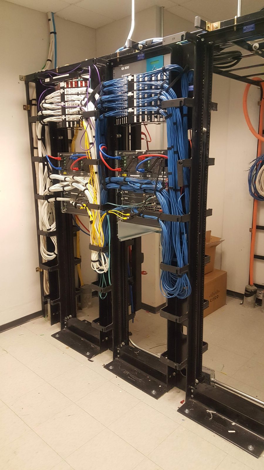 Two-post network racks with vertical cable management installed by All Soul Tech