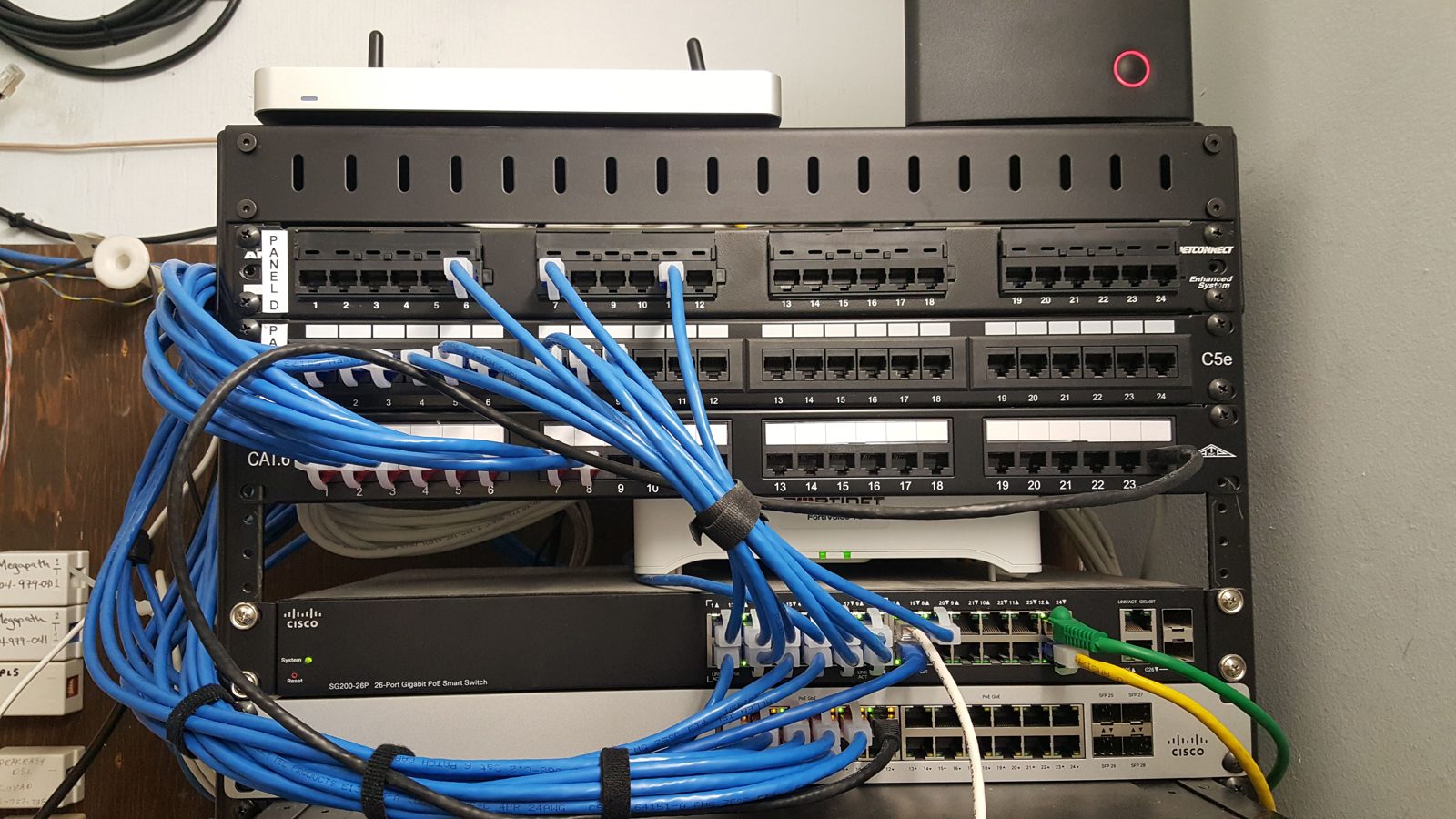 Wall-mount network rack with organized Cat6 cabling installed by All Soul Tech