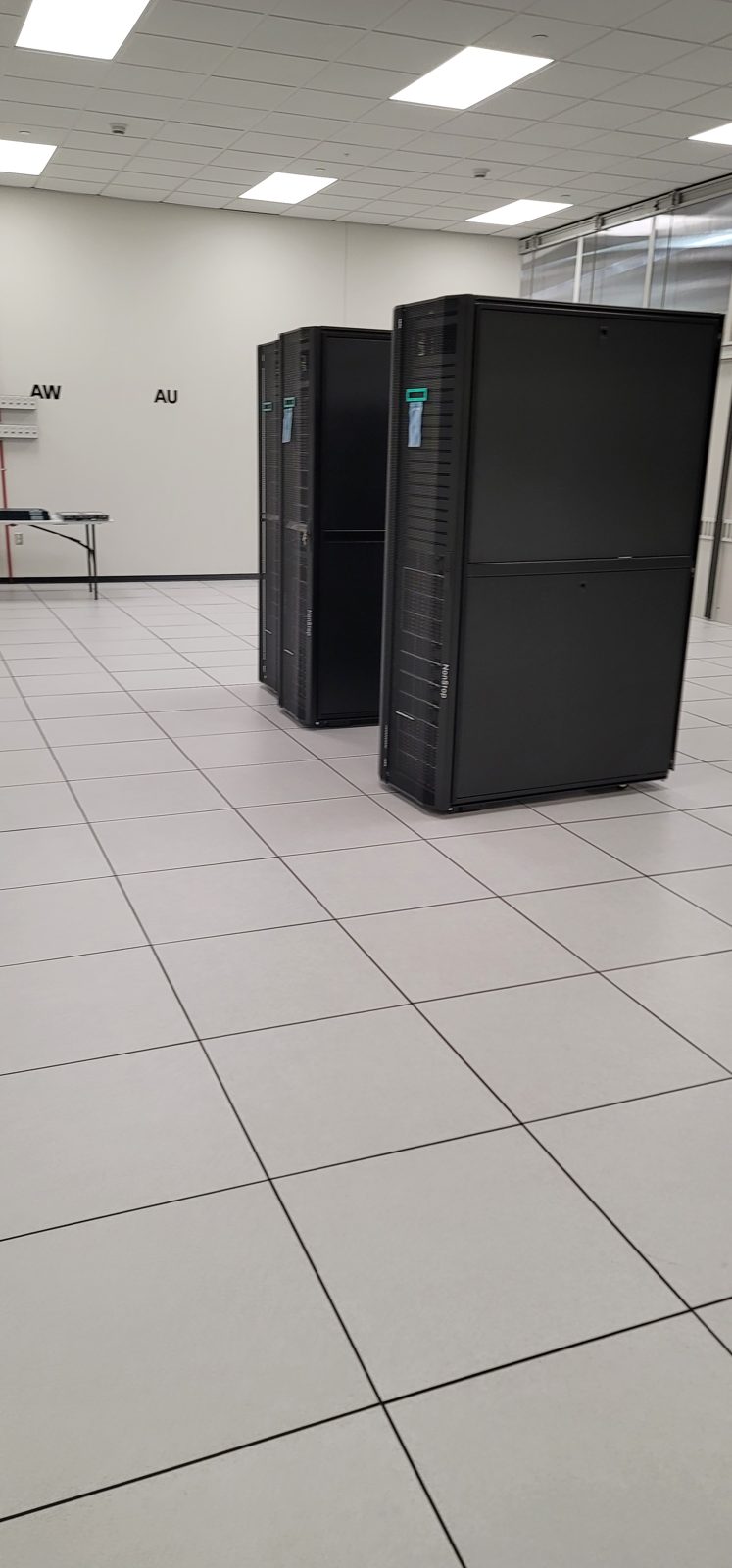 Racks installed on a raised floor in a Colorado data hall by All Soul Tech