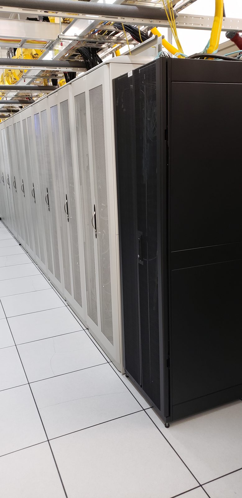 Data hall cabinet row on raised floor, All Soul Tech data center project