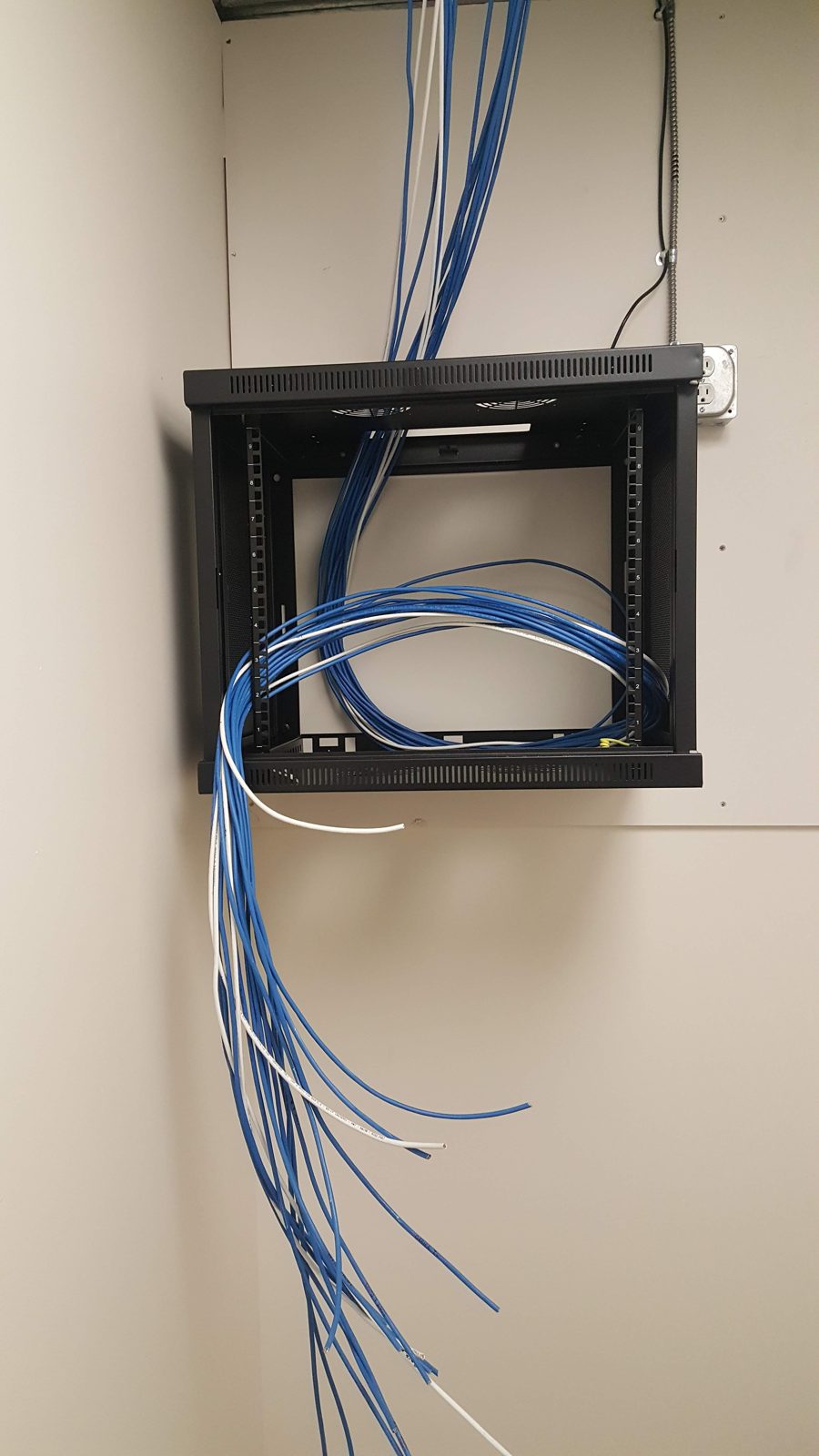 Wall cabinet cable entry installed by All Soul Tech in Colorado