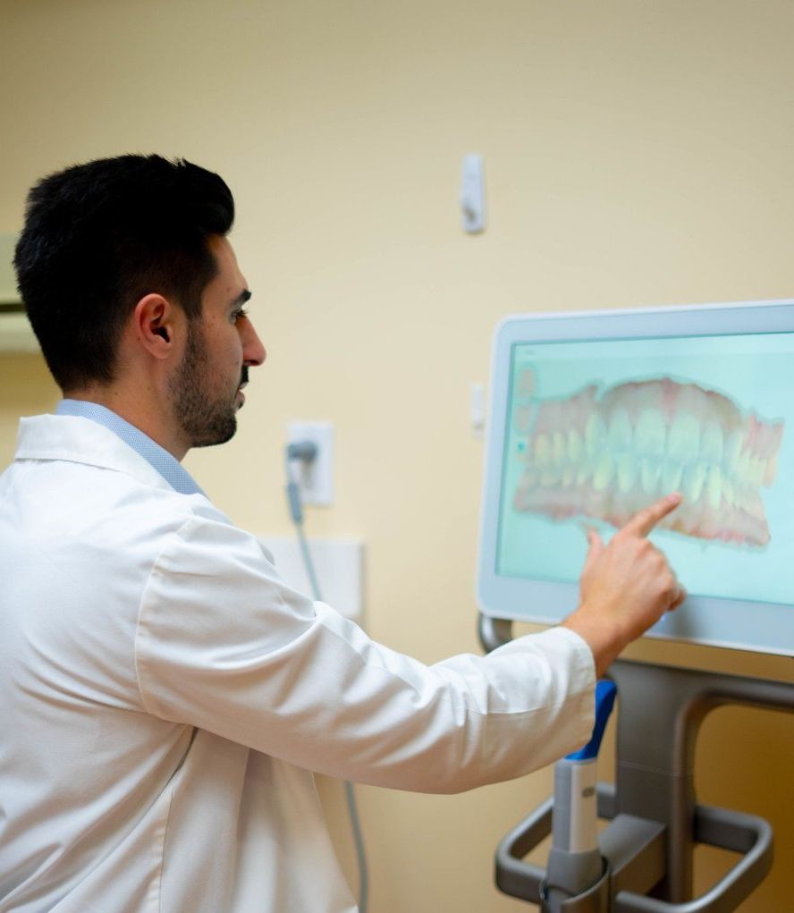 [IMAGE — Dentist performing cleaning in bright, modern treatment room]
