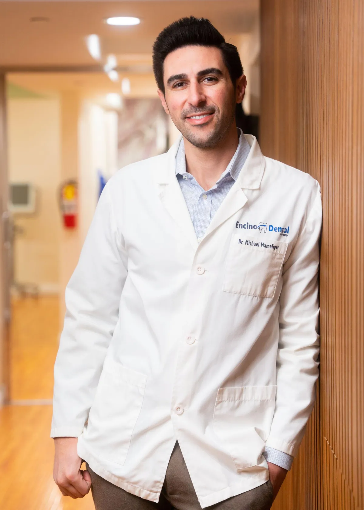 [HERO IMAGE — Doctor smiling with patient in modern dental office]