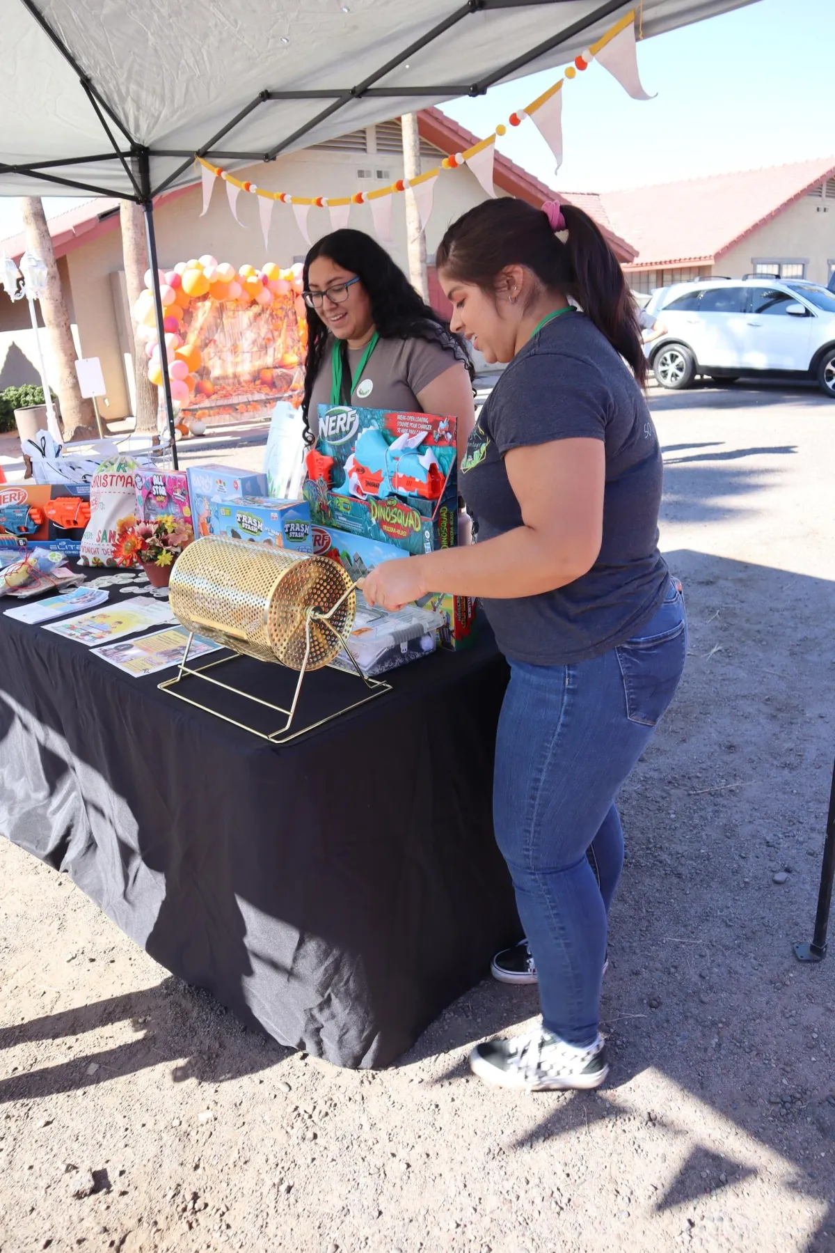 Volunteers raking colorful autumn leaves together in a neighborhood park at golden hour.