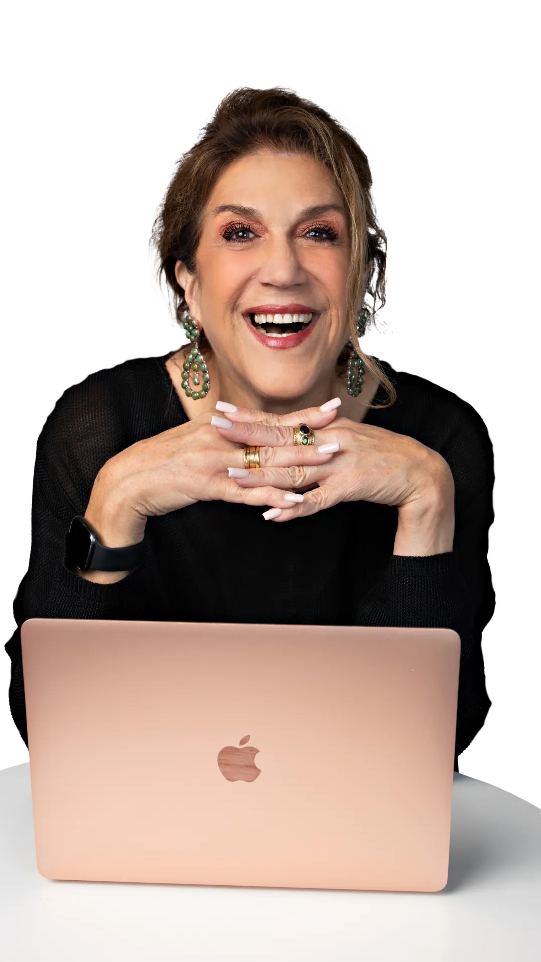 Nancy D. Solomon smiling confidently while working on her laptop, preparing to lead a transformational leadership training.