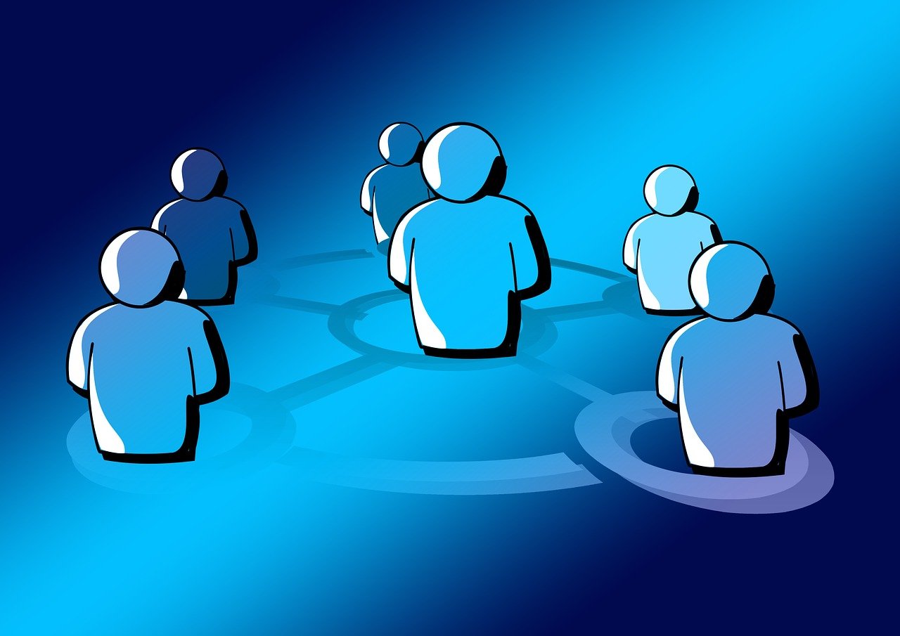 Cell tower amidst lush green trees under blue sky