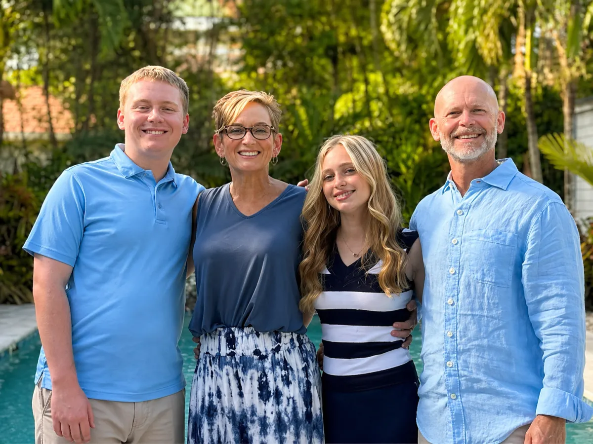Pink wispy clouds over city skyline at dusk