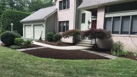 Fresh mulch and stone landscaping around a residential home