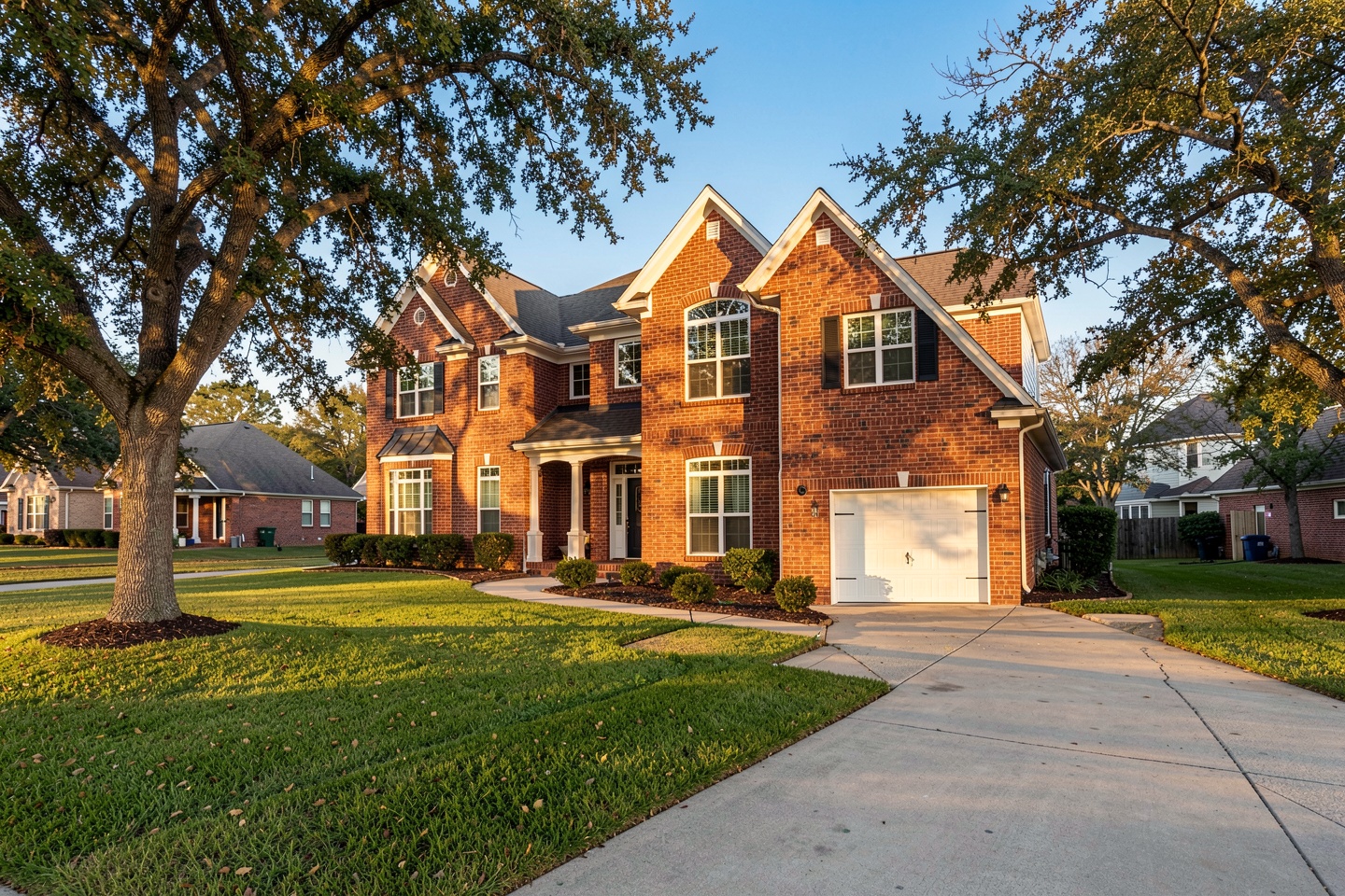 Two-story red brick home in an established Allen, TX neighborhood with mature oak trees