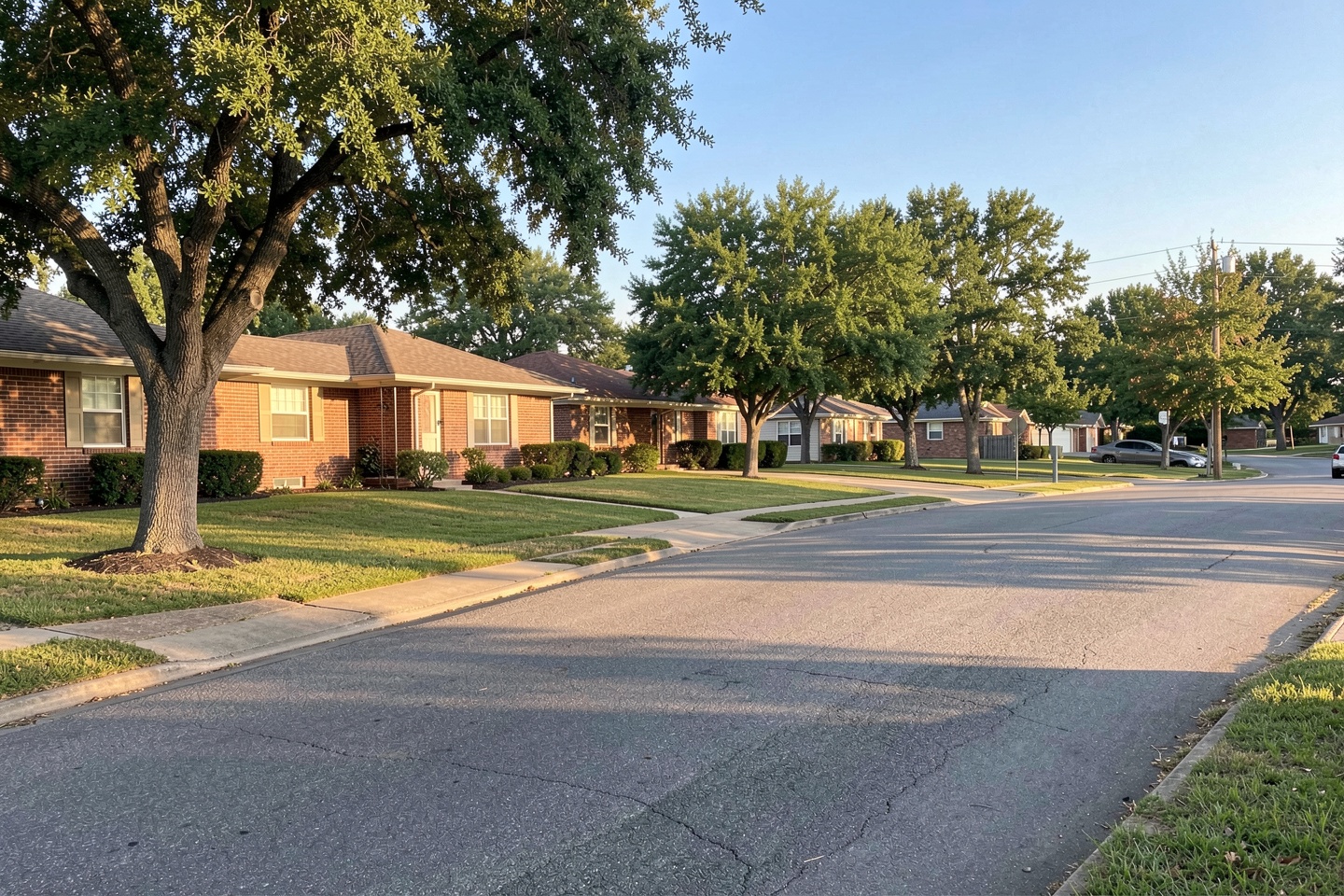 Established Arlington, TX street with 1970s and 1980s brick homes and mature shade trees