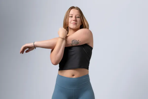 Young female athlete stretching before a workout during a fitness branding photography session, showcasing strength, confidence, and wellness for a personal brand at Jessica Korff Studios, Tucson, AZ.