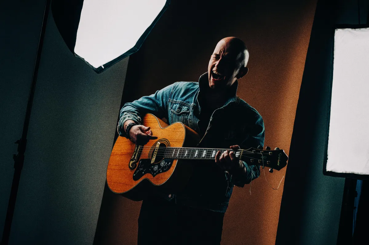 Photo of Phillip Nathanial Freeman, vocal coach, public speaking coach, vocal training, and voice lessons singing and playing guitar.