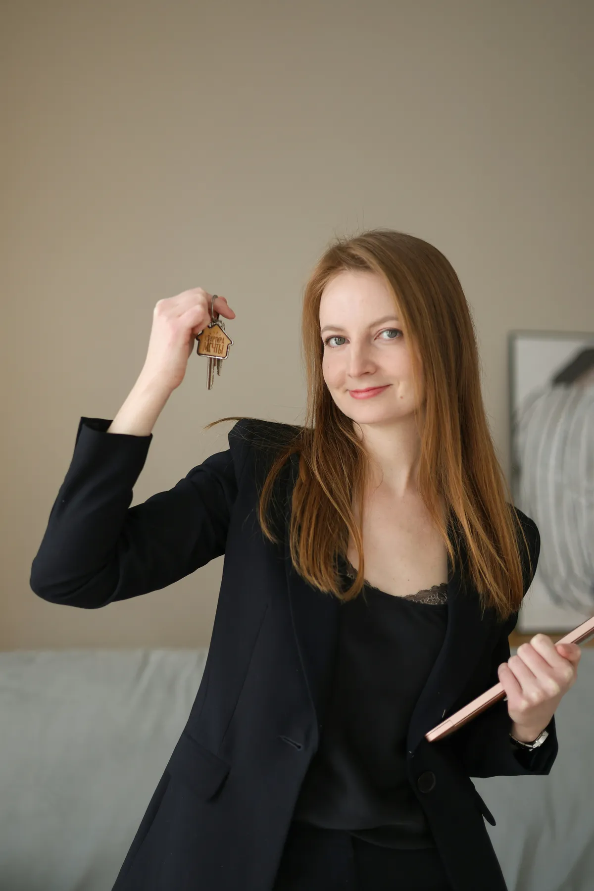 Property owner holding up keys inside a home