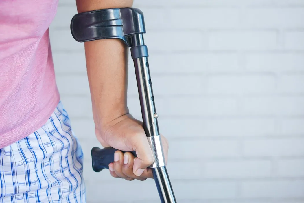 Injured person walking with a forearm crutch