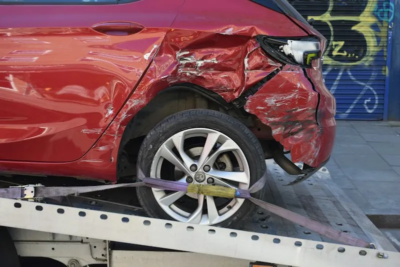 Damaged car on a tow truck after a crash