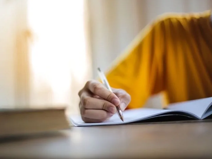 A person writing notes in a notebook