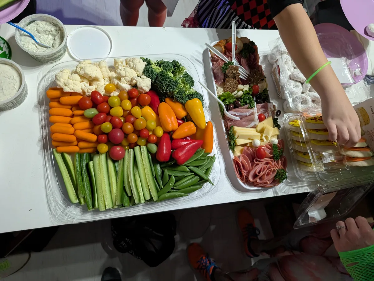 Top-down photo of event snacks and drinks with festive details