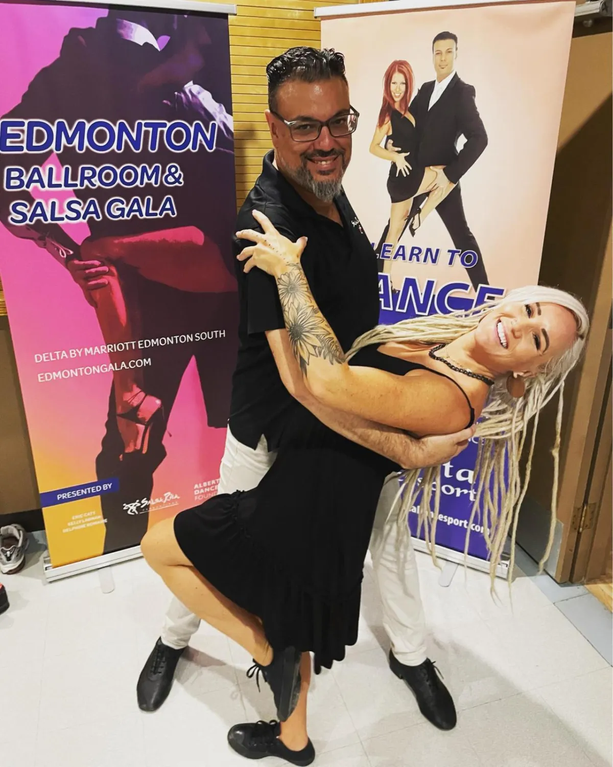Smiling young woman mid-dance with neon rim lighting, waist-up, candid portrait