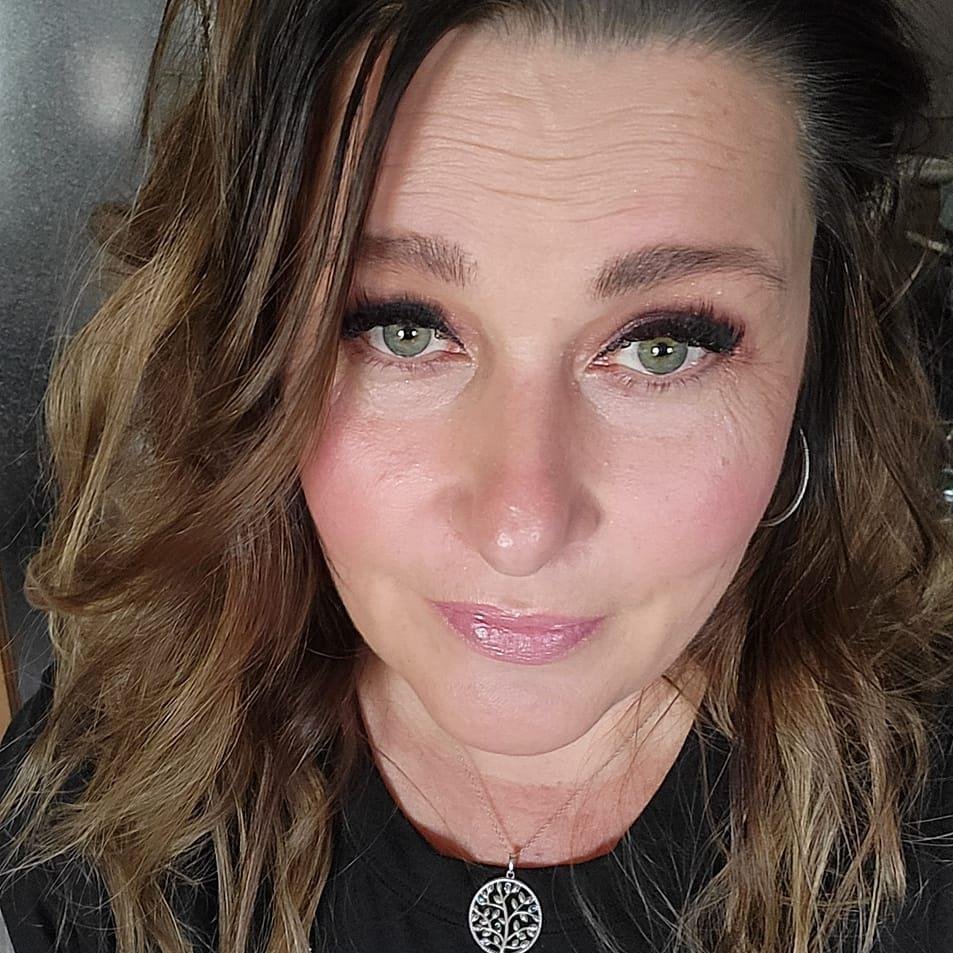 Instructor Dawn Liepert smiling in a wellness studio.