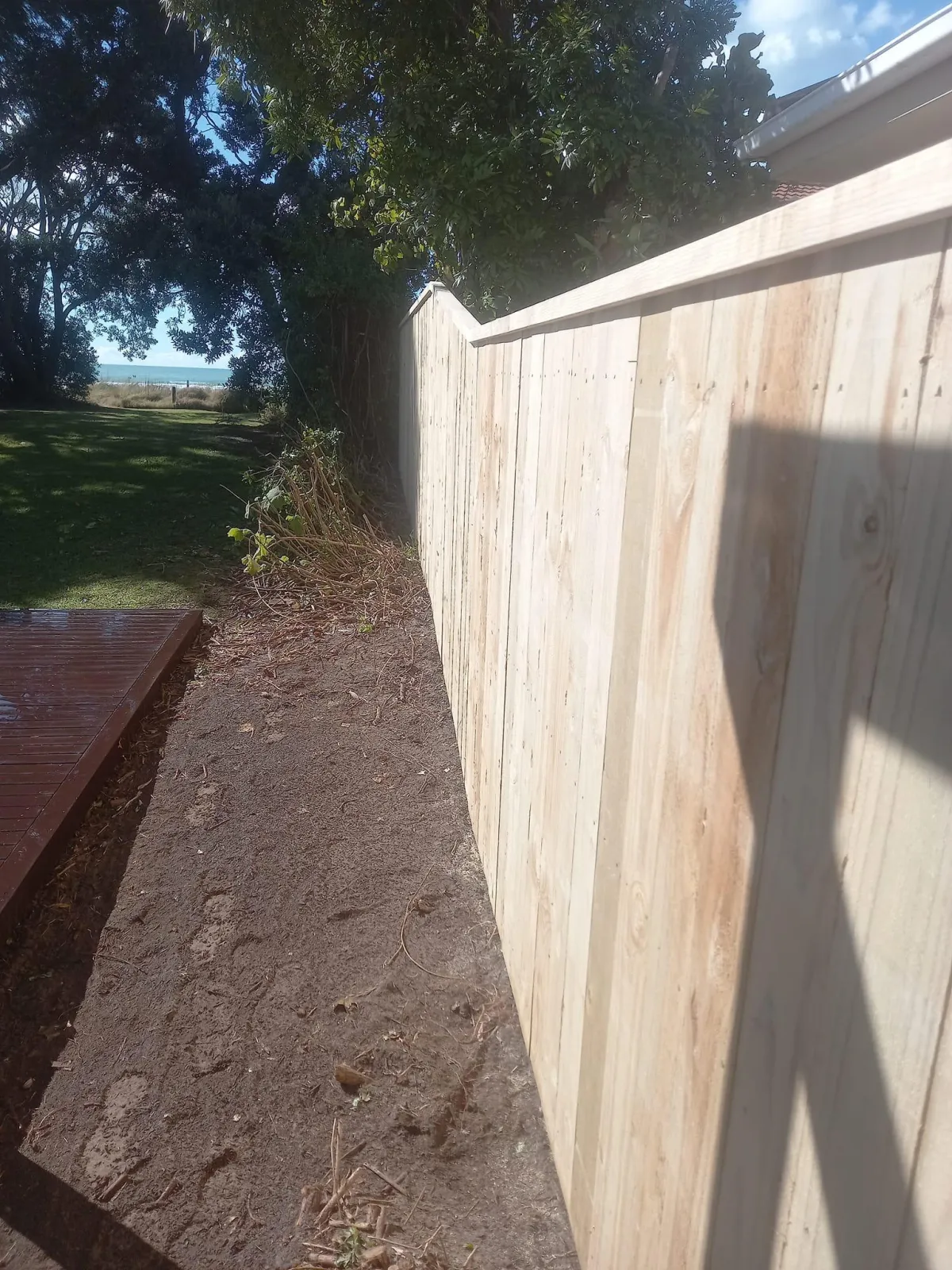 Close-up of freshly installed vertical board timber fence
