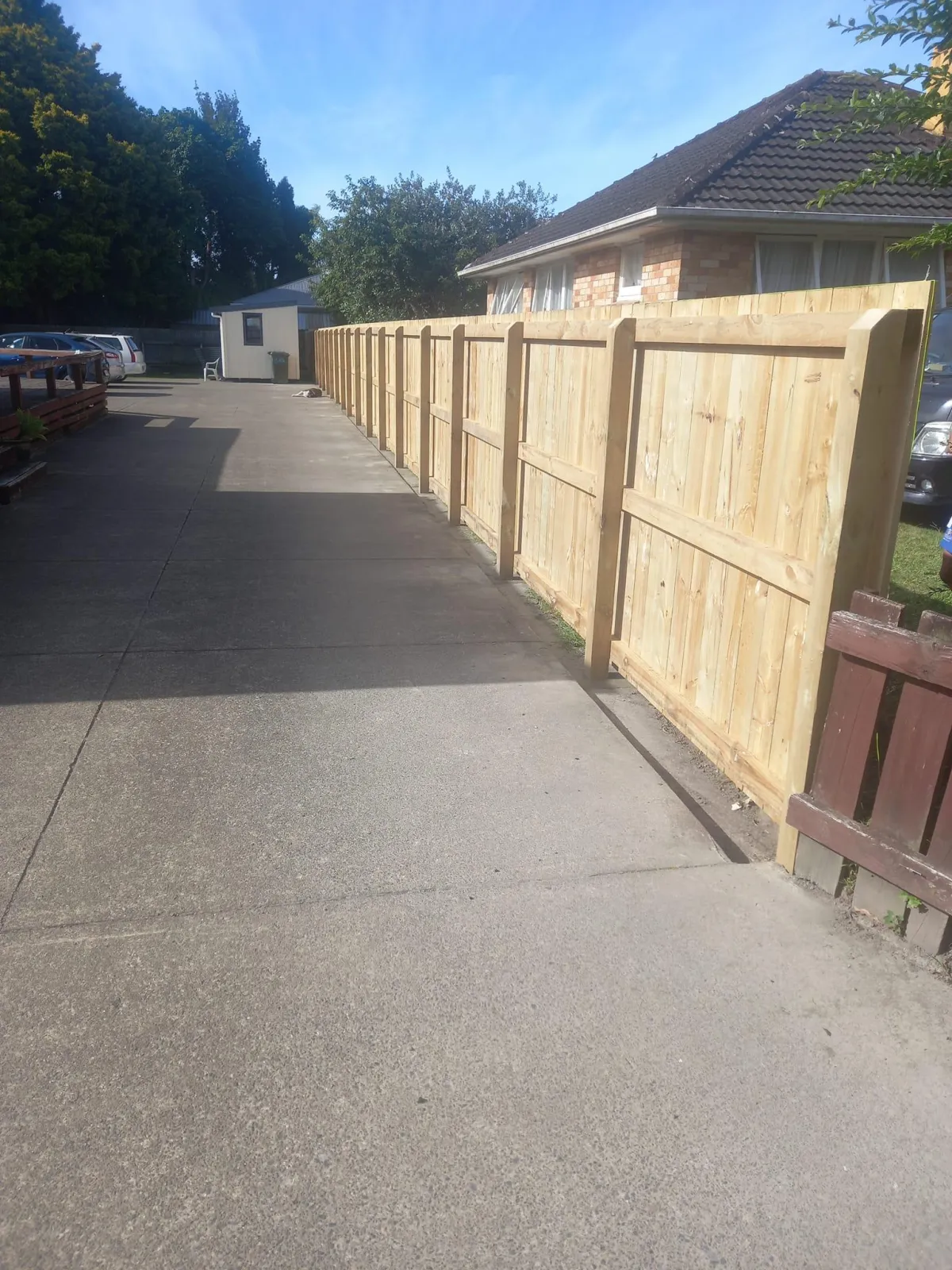 Long timber fence with driveway access in suburban Whakatane
