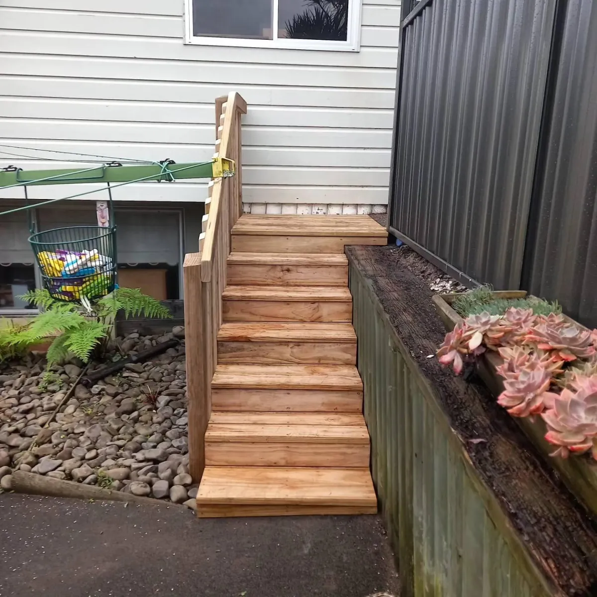 Timber walkway and stairs leading to side gate of residential home