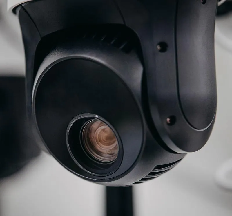 Close-up of an outdoor security camera lens showcasing advanced surveillance technology for customizable security solutions.