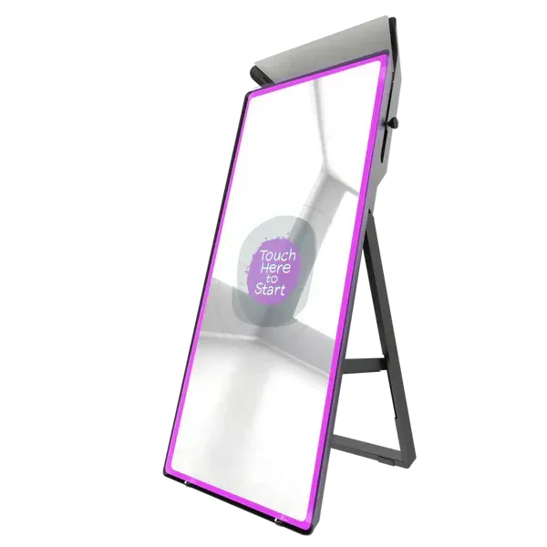 man standing while using computer and another group of men chatting