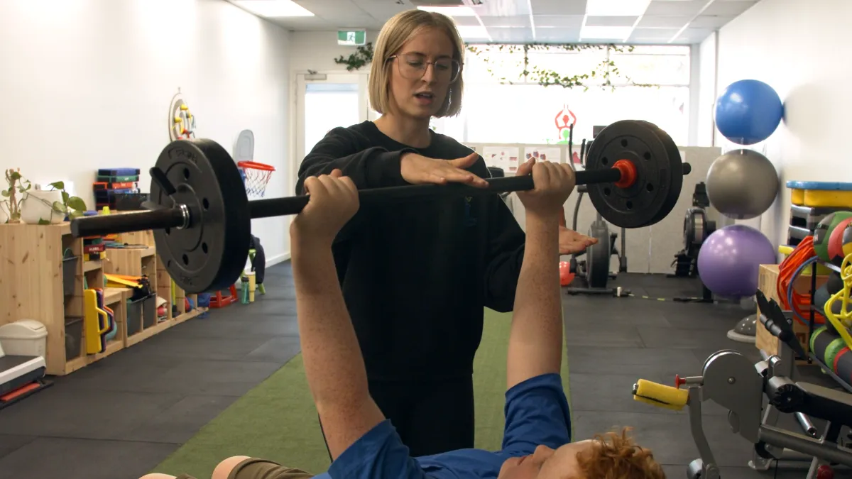 child doing weight training
