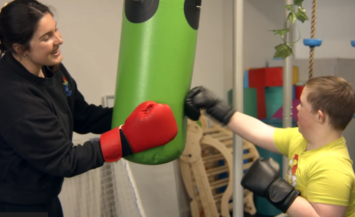 child using a boxing bag