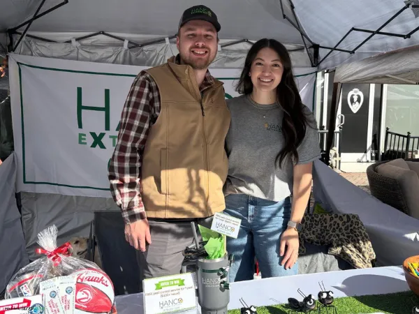 Person's hands holding a spray bottle.