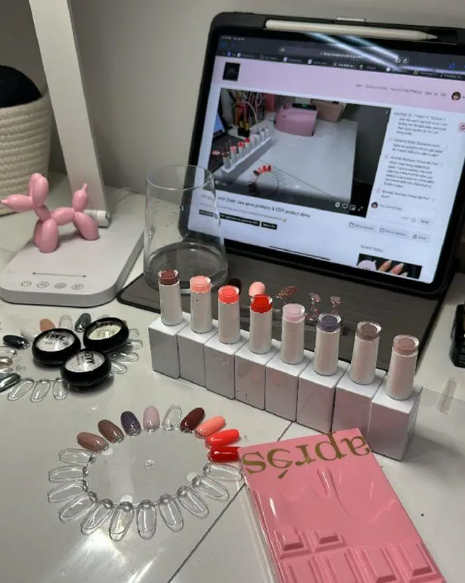 Chloe Pascarella’s desk with nail products neatly arranged for press on nail creations.