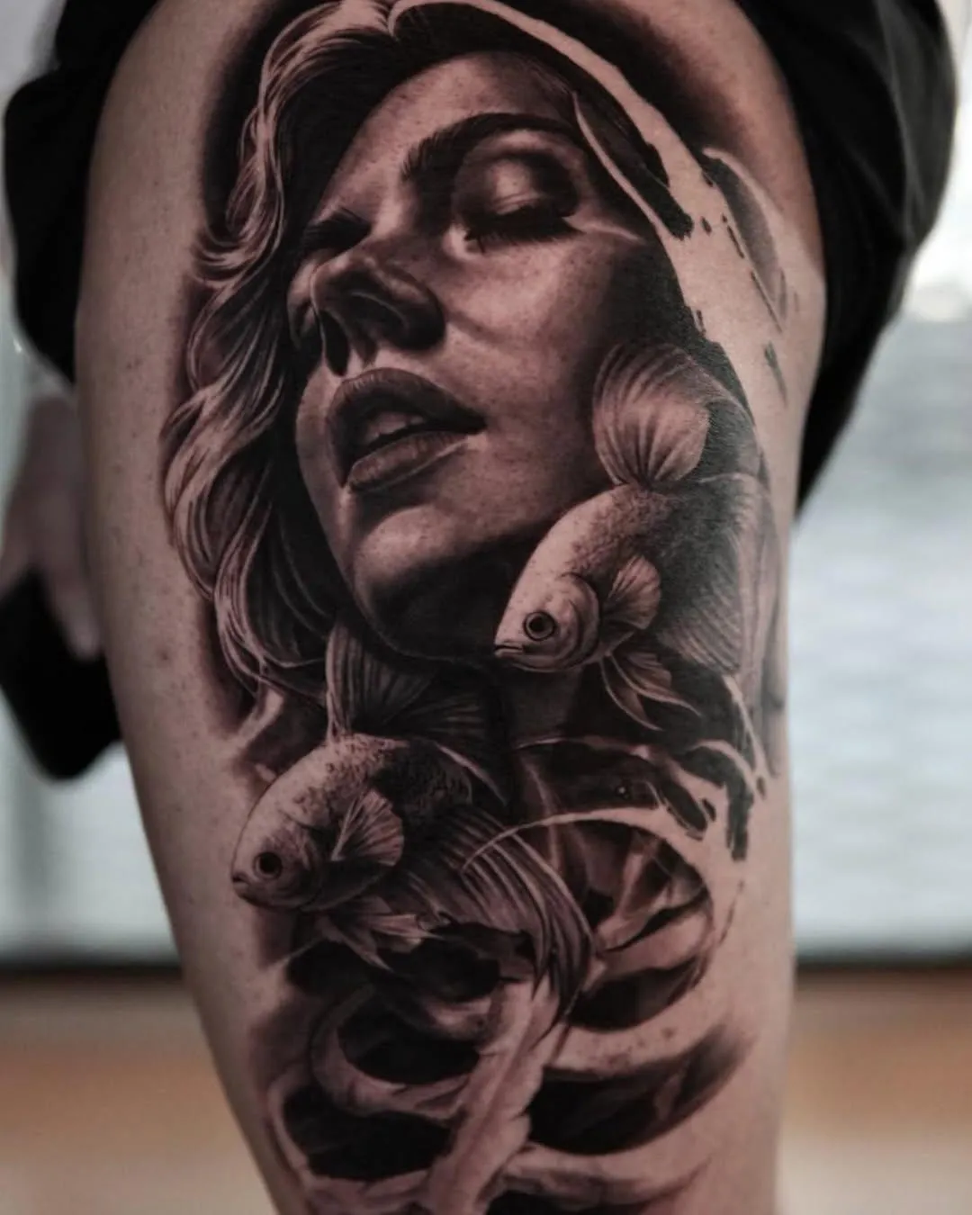 person in blue denim shorts and white nike sneakers standing on gray concrete floor