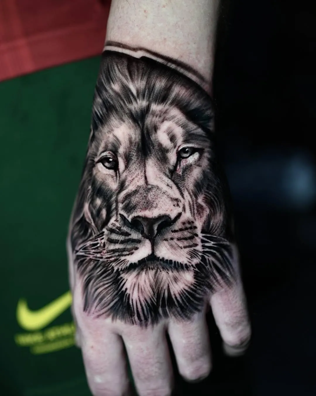 person in blue denim shorts and white nike sneakers standing on gray concrete floor