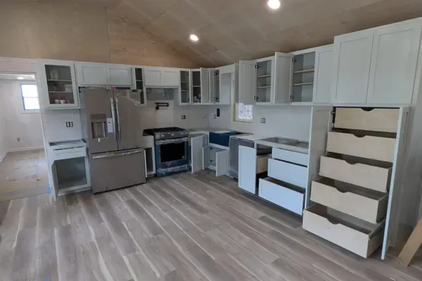 Custom kitchen cabinet installation with modern white cabinetry