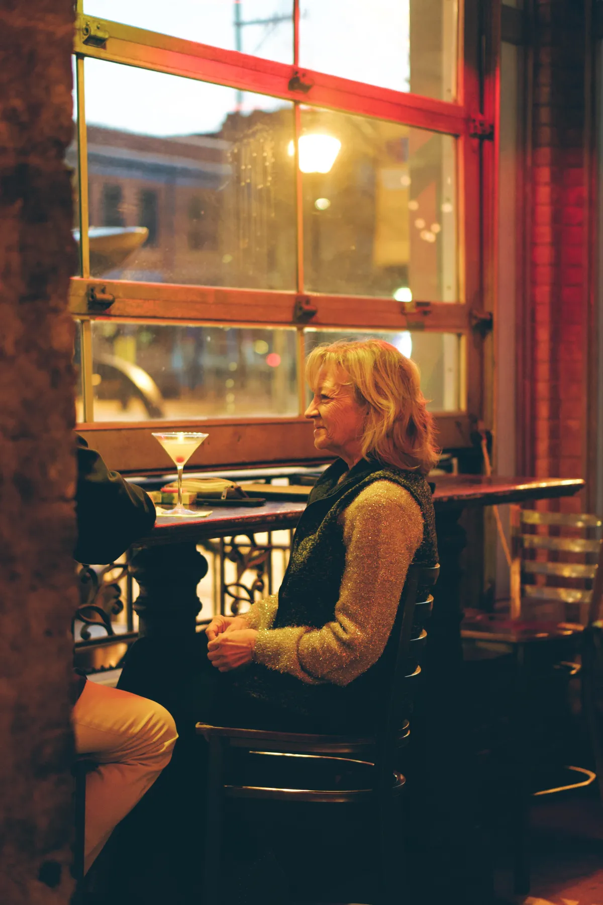 Candid moment of a guest enjoying their dining experience in a stylish restaurant.