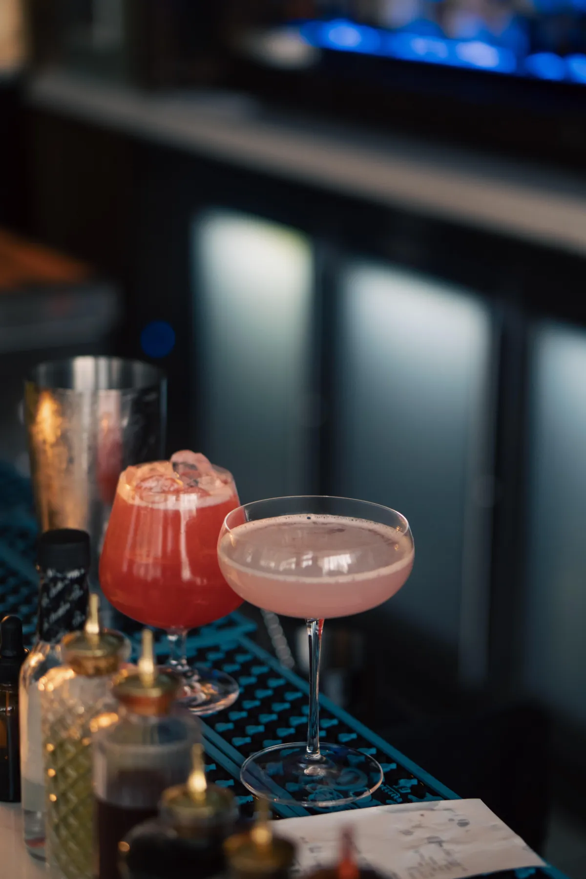 Signature cocktail served in a crystal glass with fresh garnish, captured in moody, cinematic lighting.