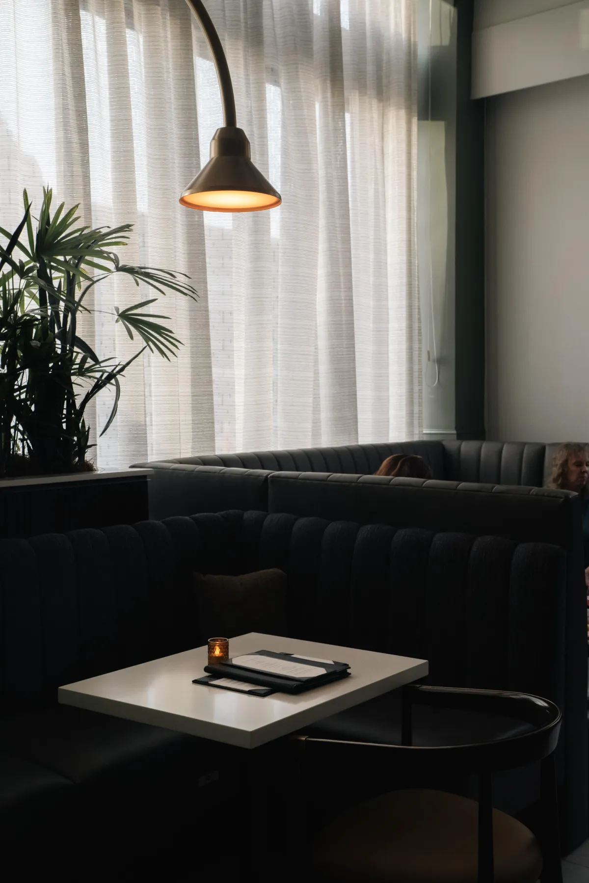 Warm, ambient lighting in a stylish restaurant, capturing the inviting atmosphere and refined decor.