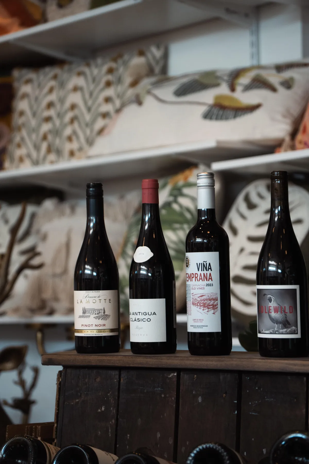 Wine bottles on a table with natural backlighting, capturing a laid-back, upscale atmosphere.