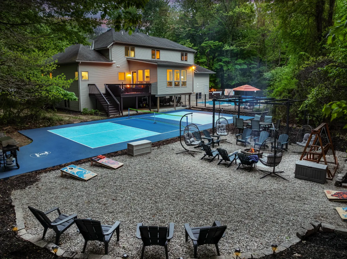 alt="Home theater room in Holland, MI vacation rental with 165" screen, wet bar, and plush recliner seating for the ultimate movie experience"