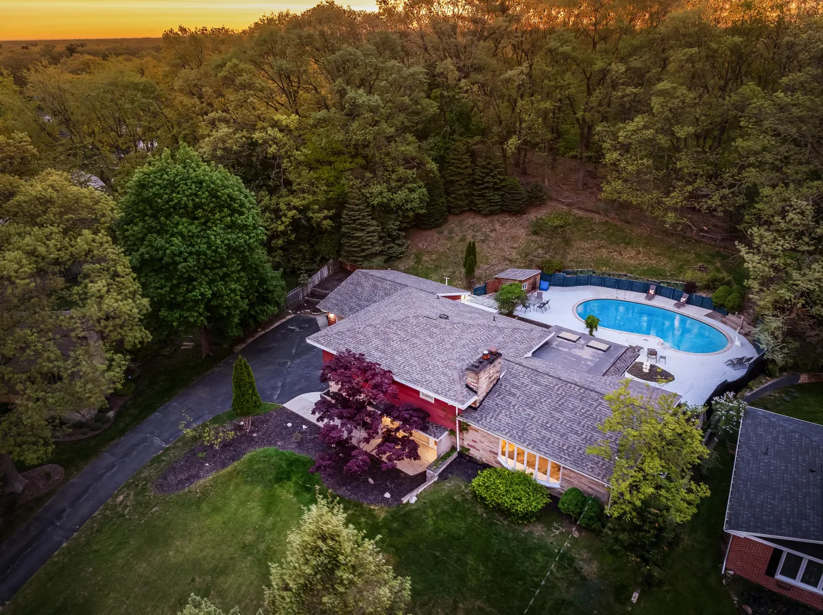 alt="The Monteview property in Muskegon, Michigan featuring an inground pool and spacious backyard"