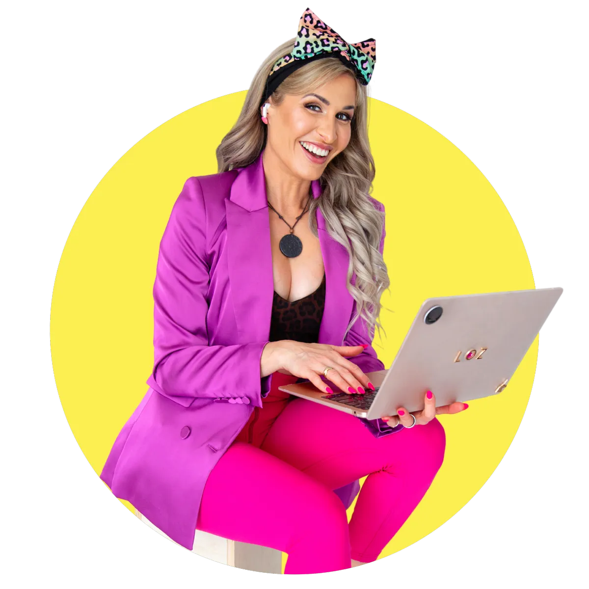 Loz Antonenko smiling while using her laptop