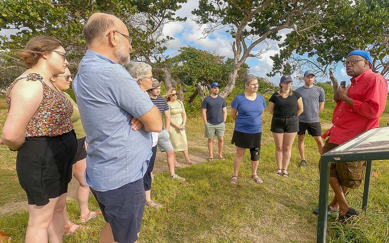 Guide briefing a small group of travelers during the early morning introduction to the In the Shadow of the Gods experience in Saint Lucia