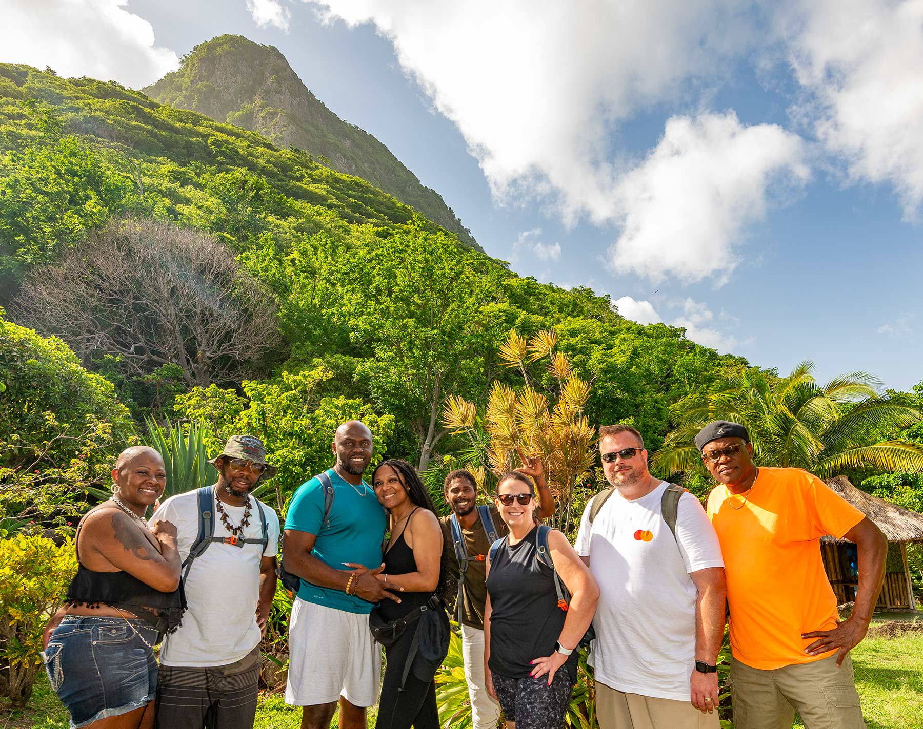 Small group of guests standing at Au Poye Park beneath Gros Piton during the In the Shadow of the Gods experience in Saint Lucia