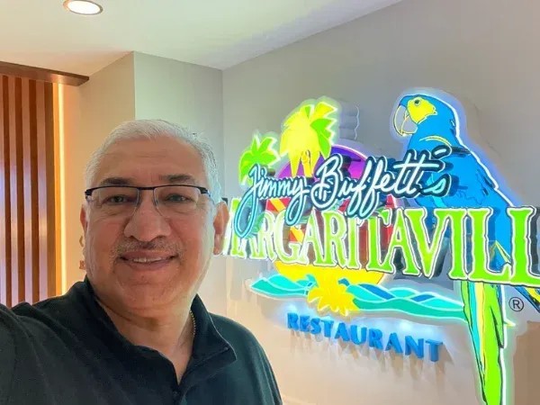 Happy customer at Margaritaville restaurant smiling after service